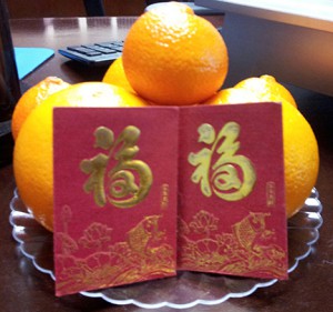 Oranges and money envelopes given for luck during the Lunar New Year.
