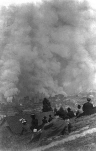 Spectators-sitting-on-hillside-watching-fires-consume-the-city-after-the-1906-san-francisco-earthquake