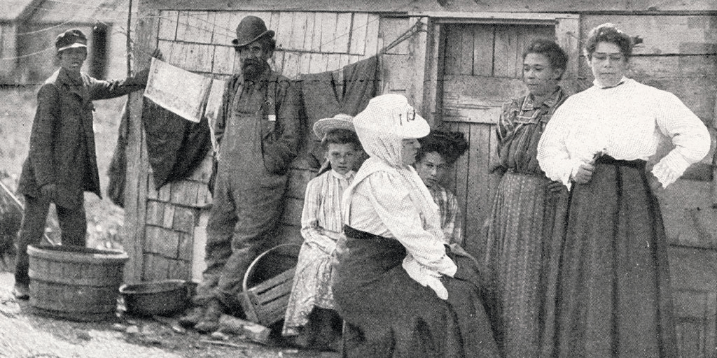 Malaga_Island_Residents_with_Missionary,_1909