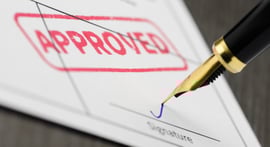 Form stamped APPROVED, pen is signing signature line