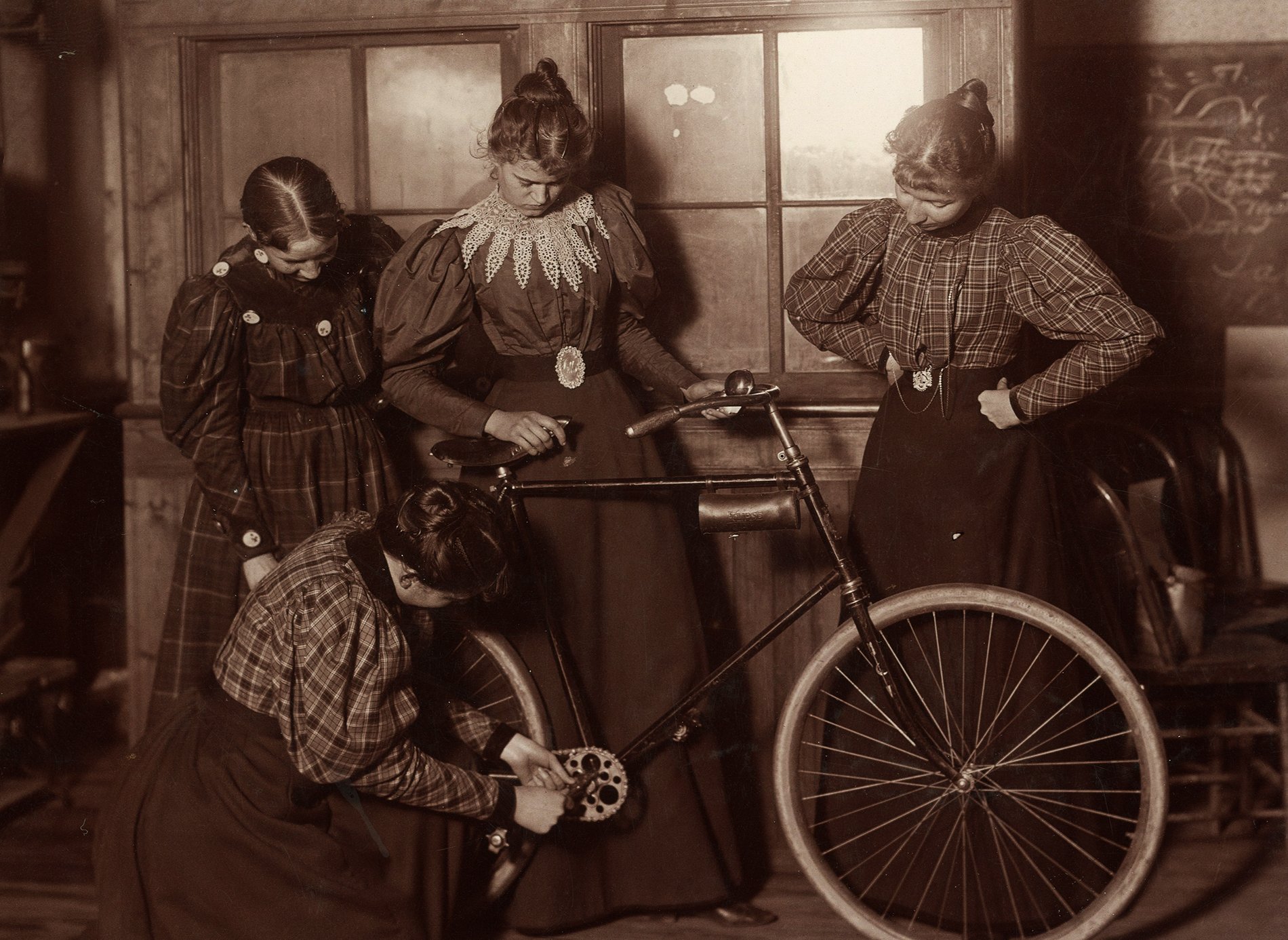 women-repairing-bicycle-c1895